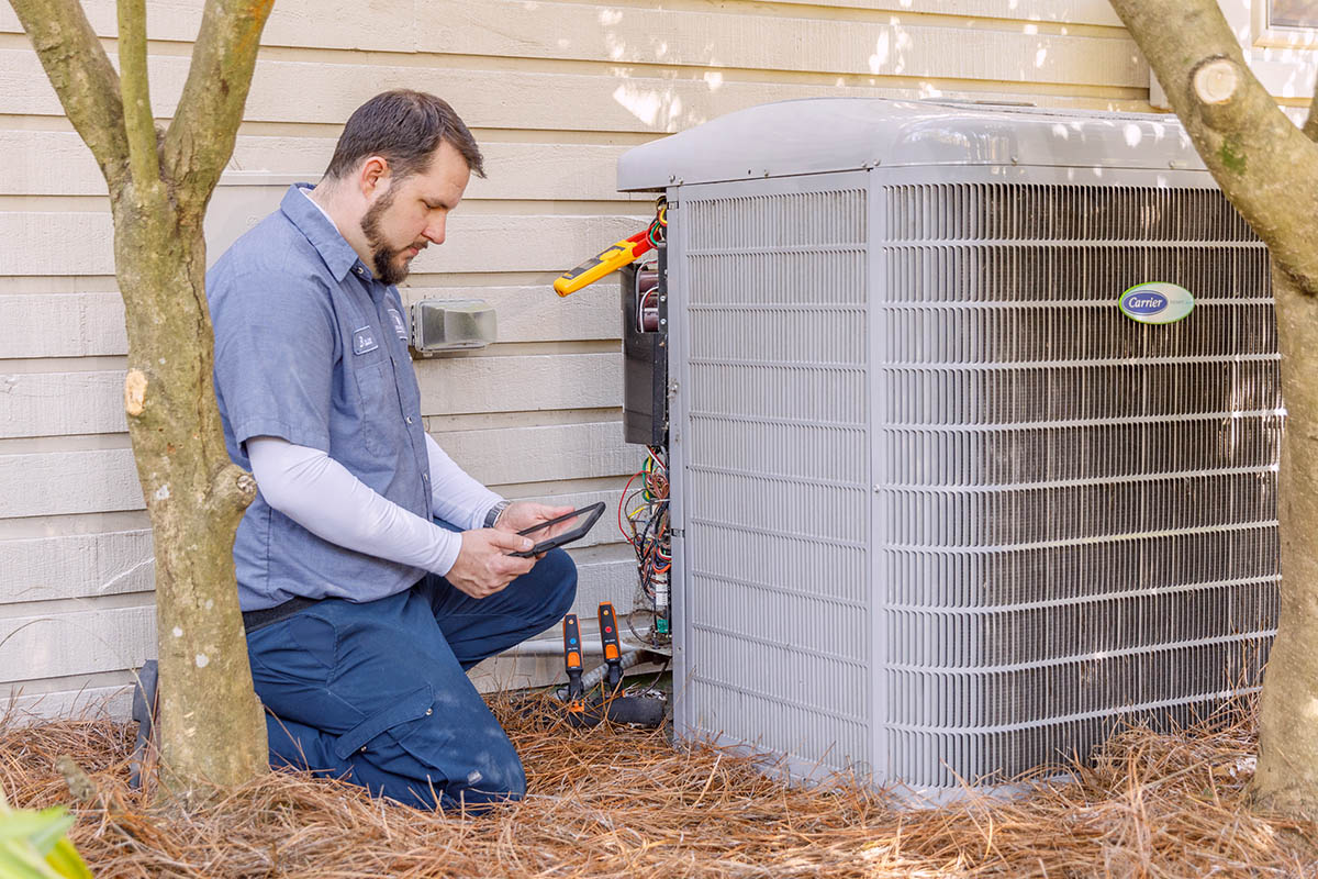 Carolina Air HVAC professional servicing a heat pump